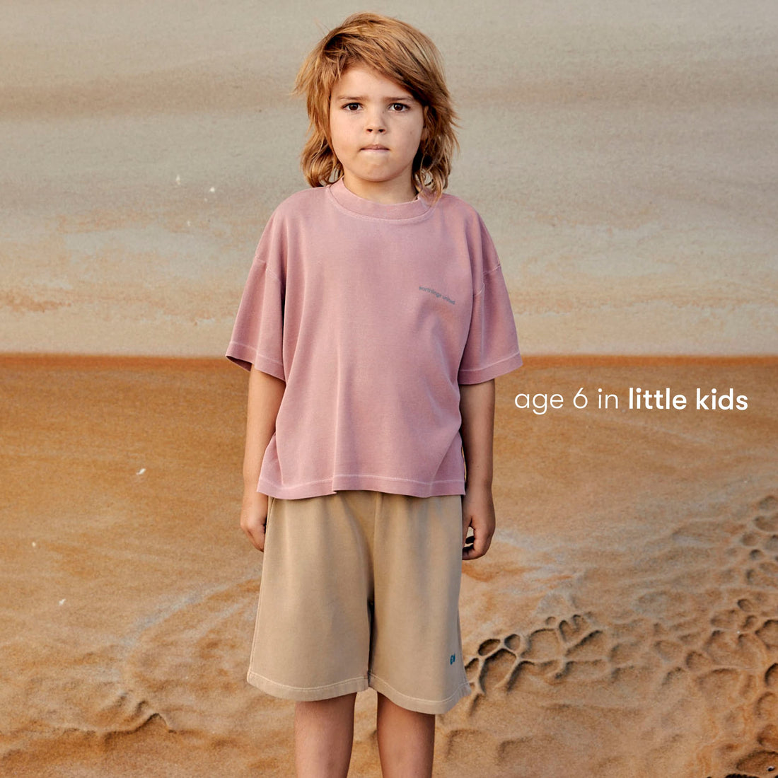 Young boy wearing a sustainable brown kids' shorts by Earthlings United, made from soft organic cotton for comfort and durability