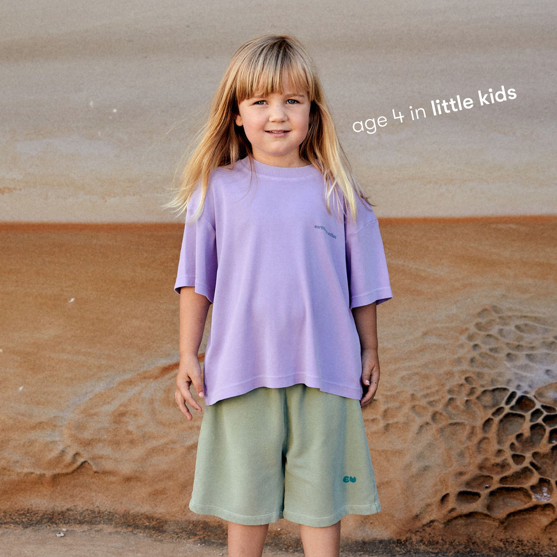 Young girl wearing a sustainable purple kids' T-shirt by Earthlings United, made from soft organic cotton for durability and comfort